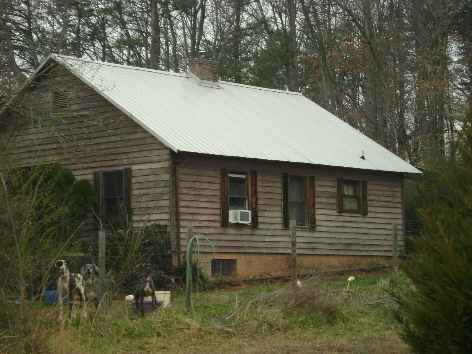 White metal roof on an old wood sided farmhouse, from a Asphalt Shingle Roof Repair job in Memphis